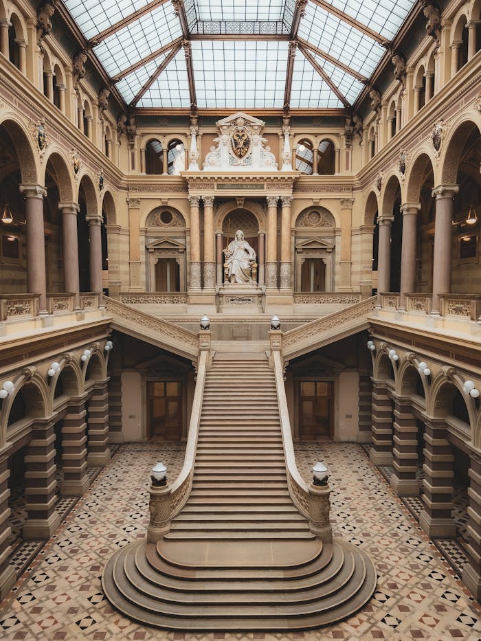 services-01 Majestic staircase inside a historic palace in Vienna, showcasing classic architecture.