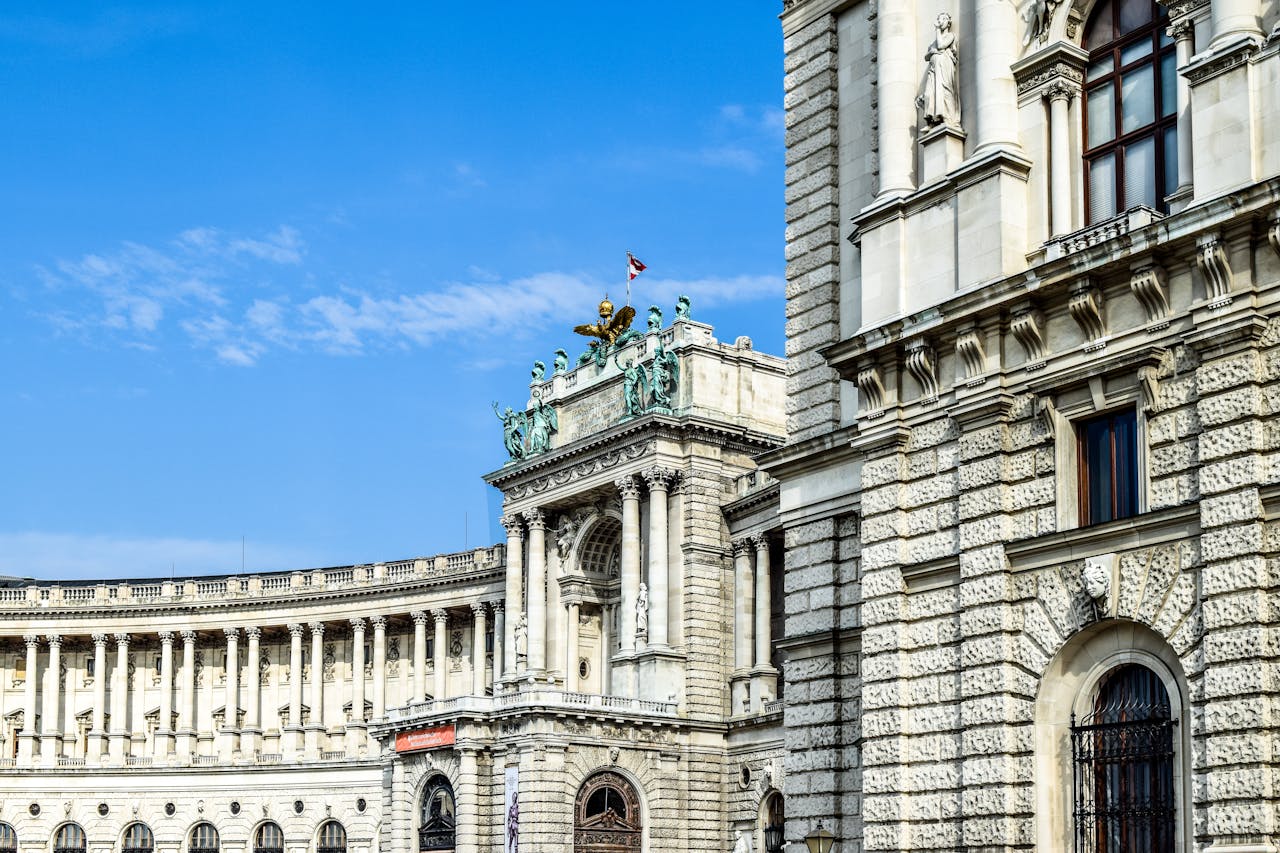 services-03 Stunning view of Vienna's Hofburg Palace exterior, showcasing its architectural grandeur against a clear blue sky.
